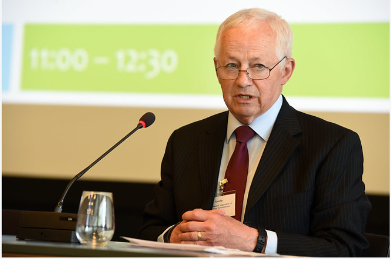 Washington State Insurance Commissioner Mike Kreidler speaking at a microphone.