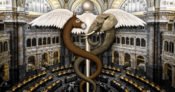 Image of a caduceus with a donkey-headed snake and an elephant-headed snake wrapped around, situated in the middle of the congressional chamber.