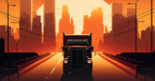 Large truck driving toward the viewer with a city and sunset behind it