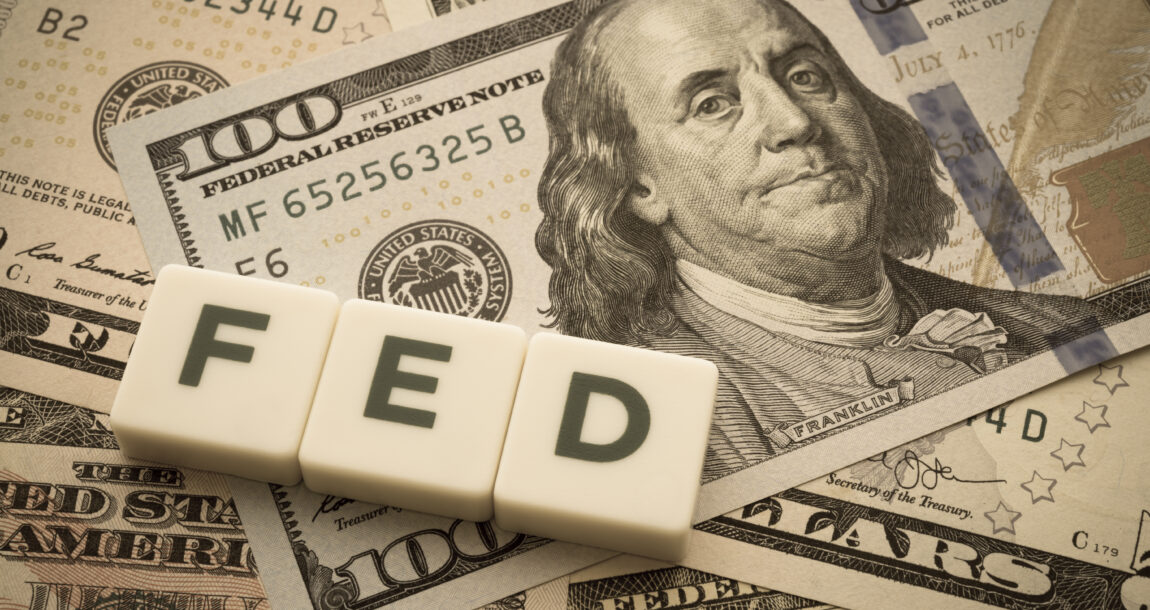 Image of word "Fed" sitting atop cash.