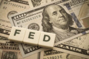 Image of word "Fed" sitting atop cash.