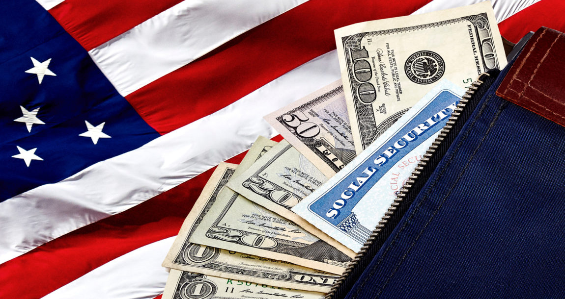 Image showing cash and social security card lying atop an American flag.