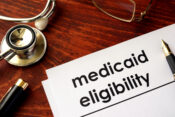 Image of forms with the word Medicaid eligibility, alongside a stethoscope. Medicaid sunset not expected to impact health insurers, analysts say.