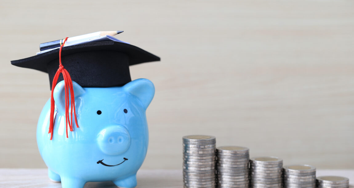 Image showing piggy bank wearing a graduation cap aside stacks of money. Study finds most Americans want to achieve financial literacy.