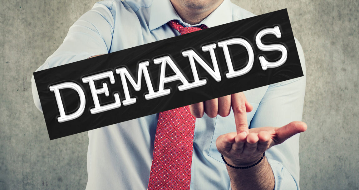 Photo shows a man with his hand out and the word "Demands" across his image.