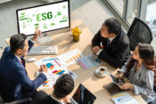 Group of people in a business meeting, with ESG information displayed on a computer screen, ESG rule 'wrong rule' to have ideological fight, analyst says.