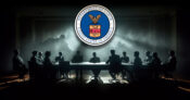 Photo shows the Department of Labor logo above a table of people sitting in the shadows.