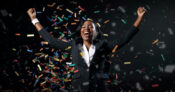Image of woman in a business suit celebrating amid confetti. Tips for financial advisors: What it takes to be a winner.