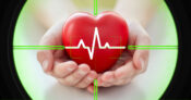 Image of hands holding a heart with an EKG line overlapping. Colorado takes aim at health care sharing plans.