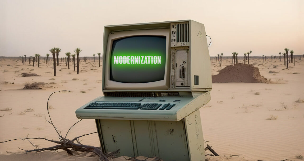 Image of an old, beat up computer with the word "Modernization" on it. Despite gains, insurance industry modernization still lags.