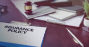 Image shows a life insurance policy on a desk.