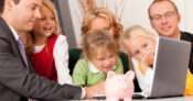 Image of a large family gathered around a desk with a financial advisor, with a piggy bank sitting on the desk. Inheritors likely to keep family advisor if relationship established early.