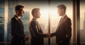 Photo of people dressed in business attire shaking hands. 4 tactics for turning client referrals into introductions.