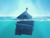 Illustration showing a person standing atop a house that is floating in water. Though risk increases, flood insurance purchases lag.