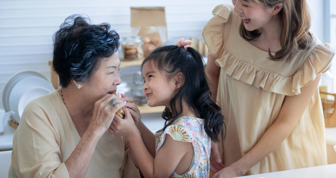 image of three generations, child, mother and grandmother, together in the kitchen.