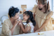 image of three generations, child, mother and grandmother, together in the kitchen.