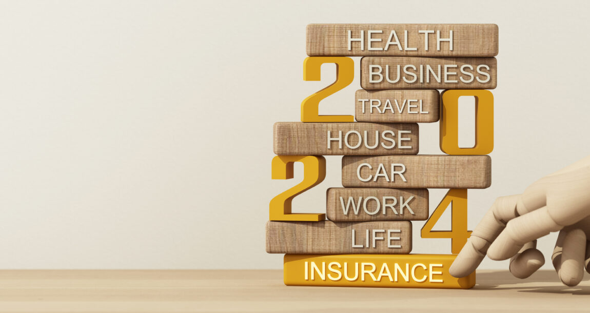 Image of small signs stacked up on the numbers "2024" that list the various types of insurance, such as life, home and health.