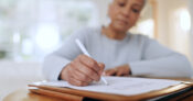 Image of a woman filling out a life insurance application.