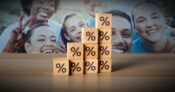Image showing photos of happy people behind ascending stacks of blocks with percentage signs. Lifting-communities-by-raising-credit-scores
