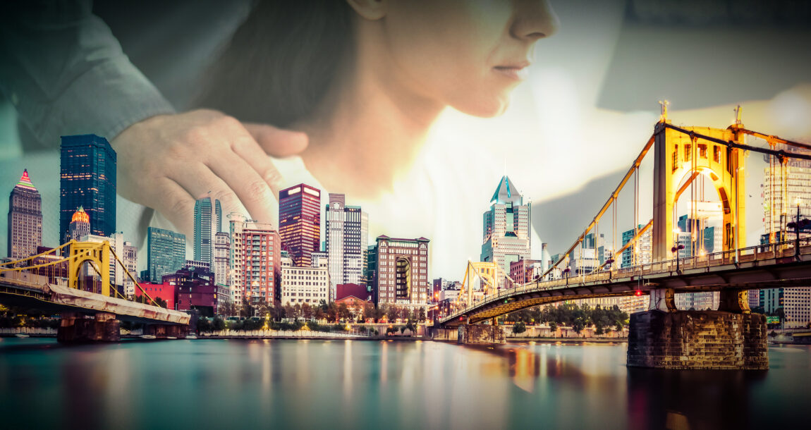 Image shows the Pittsburgh skyline with a woman in the background.