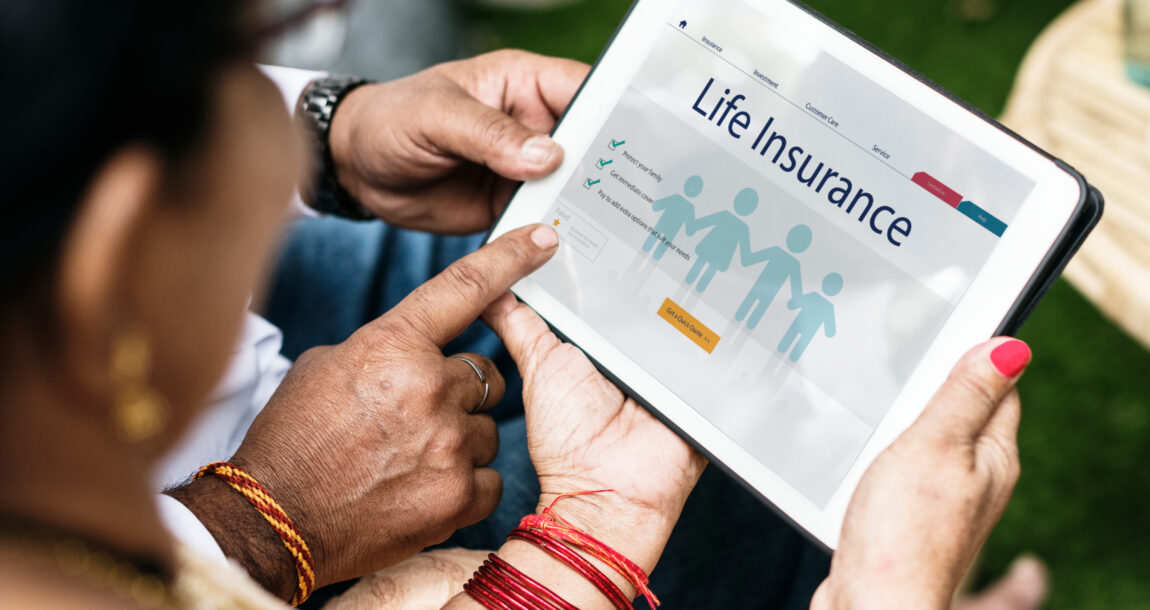 Image shows people looking at life insurance on a tablet.