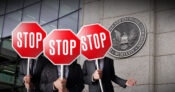 Image shows stop signs in front of the SEC building.