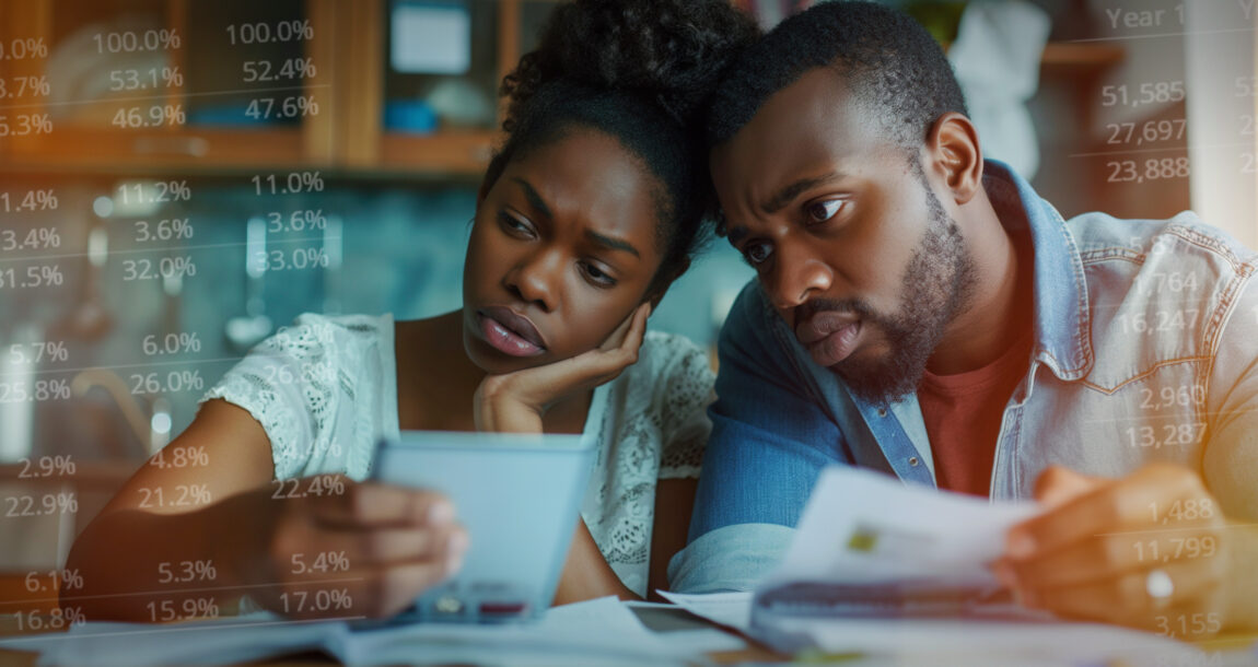 Image of a young black couple looking concerned as they look over their finances. Black-Americans-report-financial-stress-but-many-are-optimistic-about-financial-future.