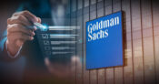 Image showing a person in business attire taking a survey, labeled Goldman Sachs. Goldman Sachs' asset management survey finds cause for 'cautious optimism'.
