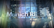 Image of Munich RE logo overlapping a modern office building. Munich-RE-says-EHRs-are-underutilized.