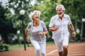 Photo of senior couple running along a track. John Hancock expands its longevity arsenal.