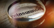 Image shows the word "reinsurance" inside a magnifying glass.