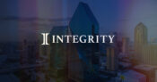 Integrity logo against a backdrop of financial buildings and skyline. Integrity-Marketing-Group-adds-wealth-management-division.