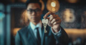 Image shows a man holding keys.