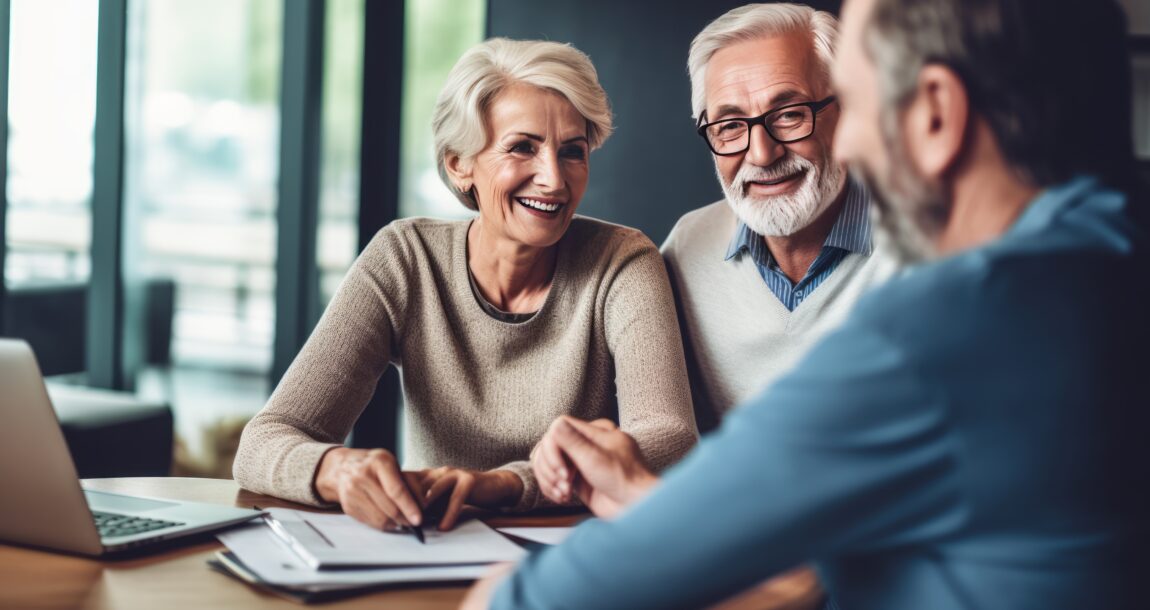 Image of a financial advisor and two senior age clients who look happy. Senior couple meeting financial advisor for investment.