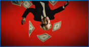 Image shows an upside down Greg Lindberg and money floating around