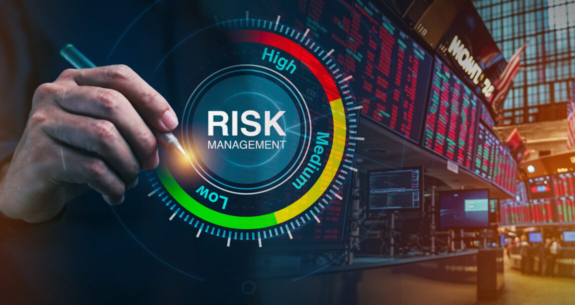 Image of a person dialing down risk on a "Risk" dial. Investors-reduce-risk-in-reaction-to-market-volatility.