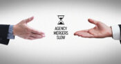 Photo illustration showing two hands moving apart rather than shaking hands, with the title "Agency Mergers Slow." 2024-insurance-agency-mergers-slow-show-signs-of-surge-in-2025.