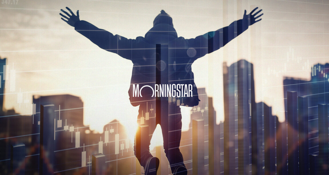 Photo illustration of a figure jumping for joy against the background of a city financial district, with the logo of Morningstar overlapping. Economy-performing-better-than-expected-Morningstar-says.