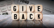 Illustration showing blocks that spell out "Giving Back." Charitable-giving-tools-are-available-for-taxpayers.