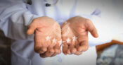 Image of a medical professional with five stars across his open hands. Group health: What sets high-ranked plans apart?