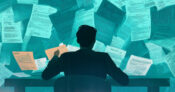 Image shows a man at a desk with papers around the background