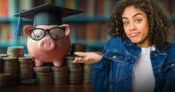 Person beside at piggy bank standing atop stacks of coins, and wearing a mortar board. Study-finds-that-many-Americans-don't-know-about-529-plans.