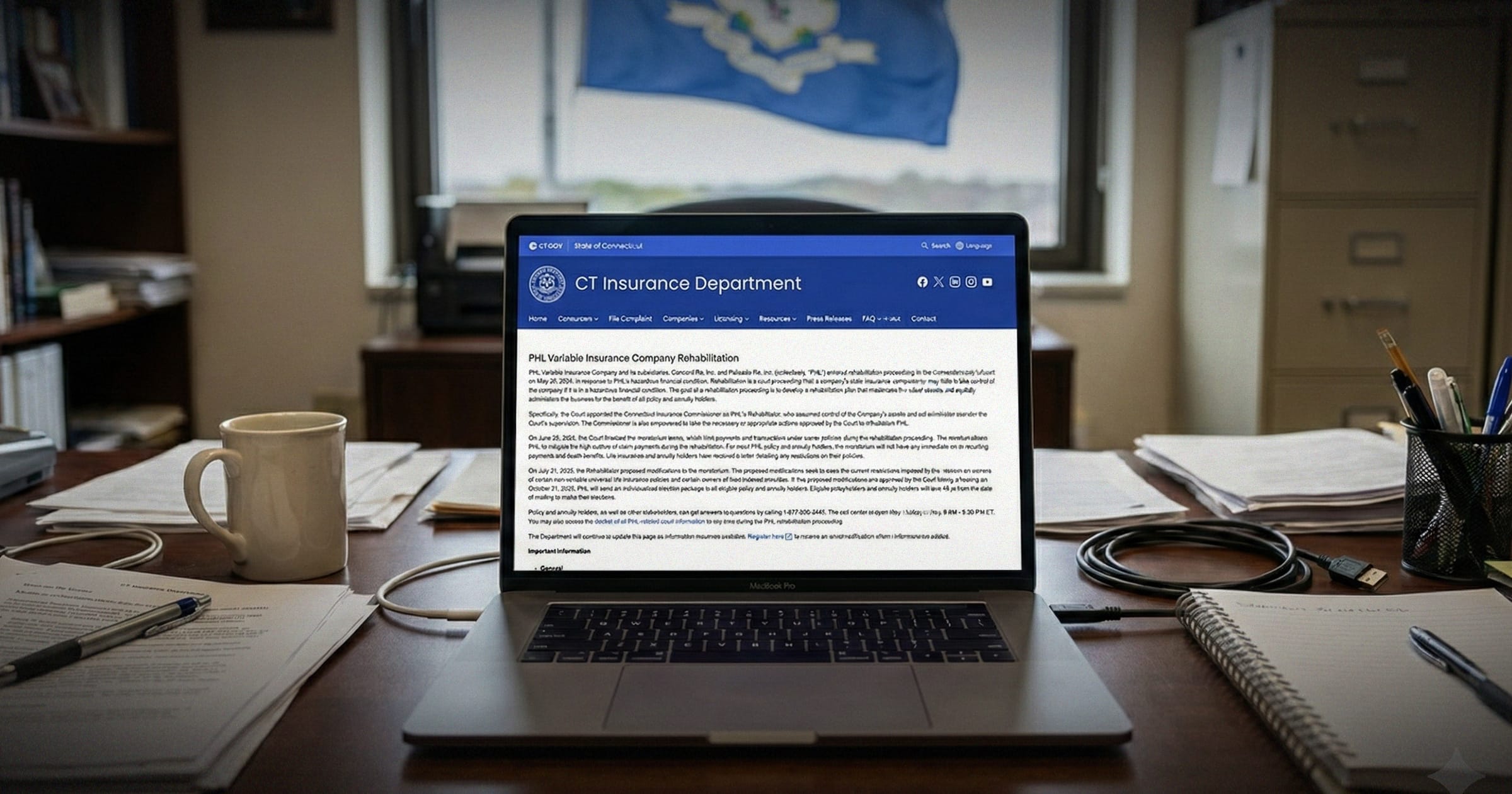 Image shows a laptop open to the Connecticut Insurance Department website.