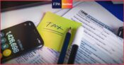 Image shows a tax form with a sticky note