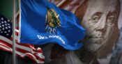 Image shows the flags of Oklahoma and the US.