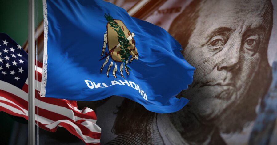 Image shows the flags of Oklahoma and the US.