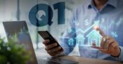 Image shows "Q1" and a man holding a cell phone