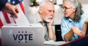 Image shows a couple preparing to vote.