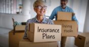 Image shows a family carrying boxes labeled as financial and insurance plans.
