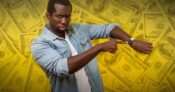 Image shows a man pointing at his watch